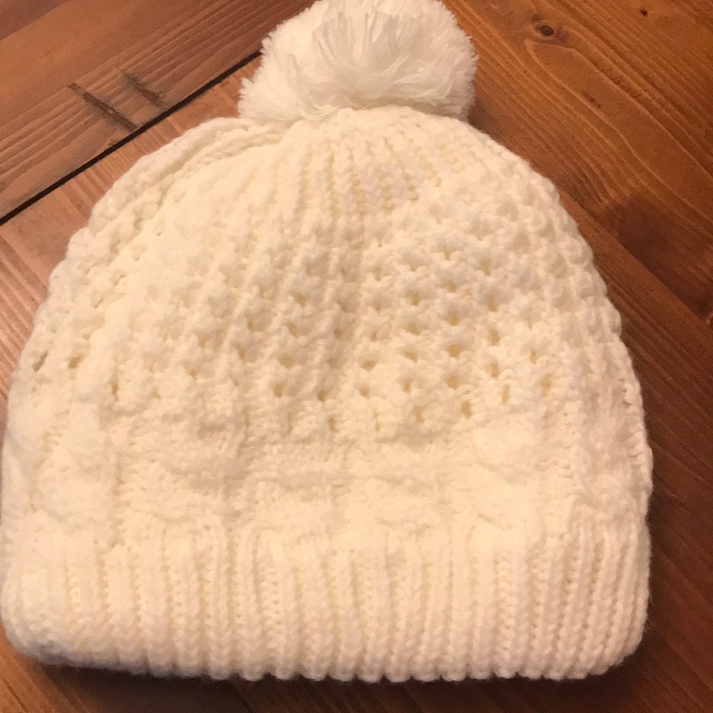 Cream hat with a Pom Pom on top